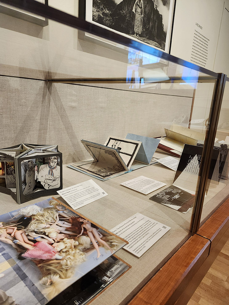Artists' books on display in a glass exhibit case