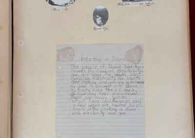 Picture of a handwritten page from a circa 1940 school class history describing the use of coal, oil, gas, wood, and electricity for heating.